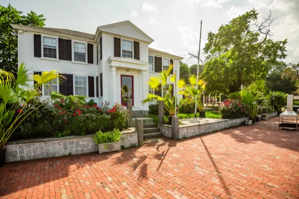 The front of the bed and breakfast, white columns above the brick drive
