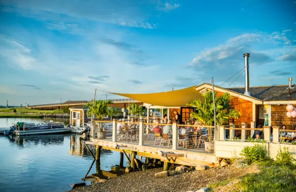 The Boathouse Bar deck seen from the water under a deep blue sky