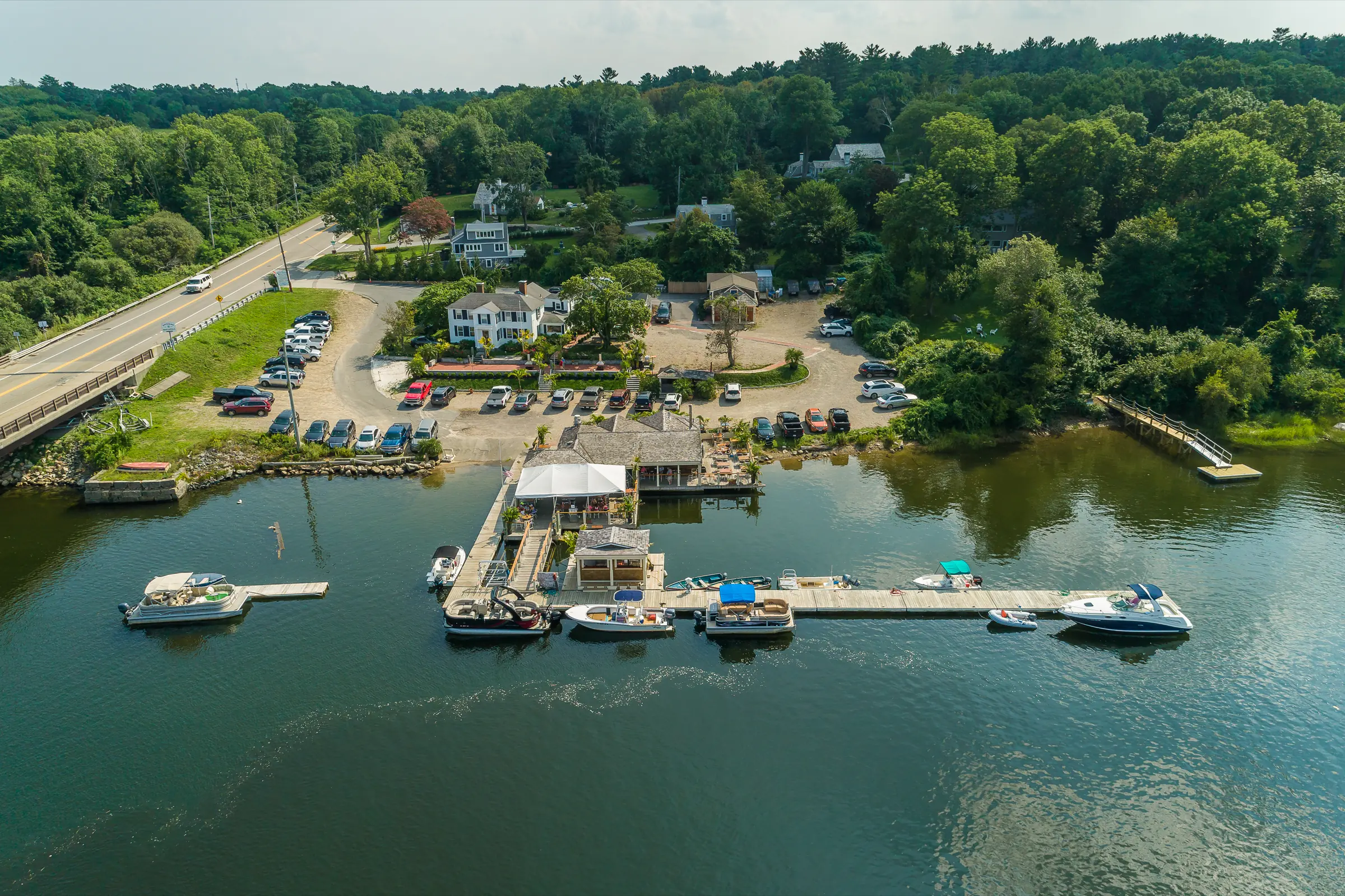 Aerial view of the marina docks and moored boats beside the Green Harbor bridge
