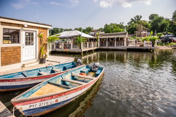 Two painted wooden skiffs tied alongside the dock at Green Harbor