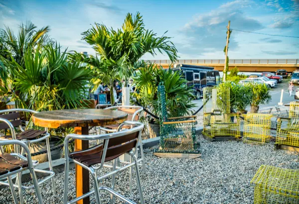Outdoor tables beside stacked yellow lobster traps